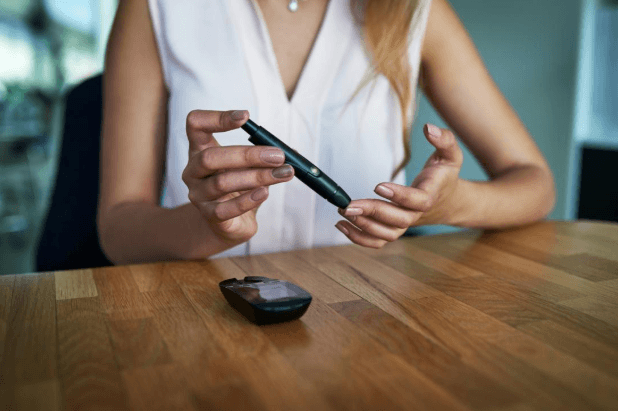 Woman checking blood sugar