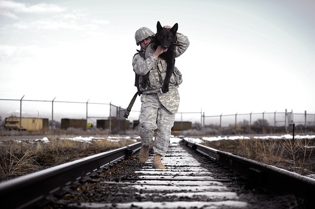 soldier carrying a dog